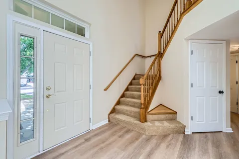 a view of entryway with wooden floor and stairs