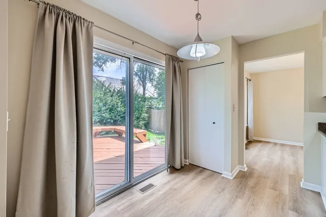 a view of an entryway with wooden floor and door