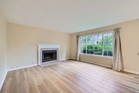 wooden floor fireplace and natural light in room