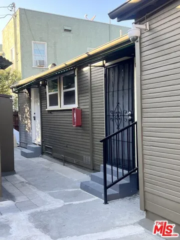 a view of backyard of house and deck