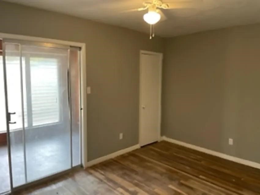 105 Dooley Street Prairie View, TX 77446 - Photo 8 of 8 a view of an empty room with window wooden floor and brick walls