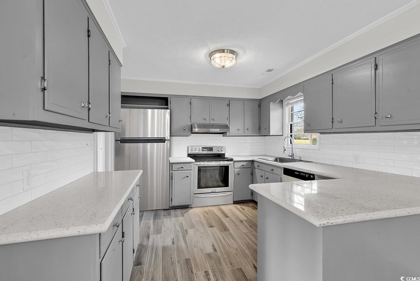 4320 Stevens Street Loris, SC 29569 - Photo 11 of 33 Kitchen with gray cabinetry, under cabinet range h