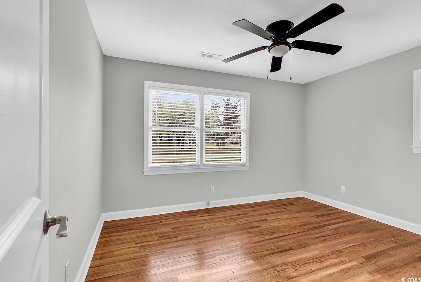 4320 Stevens Street Loris, SC 29569 - Photo 16 of 33 Spare room with visible vents, wood finished floor