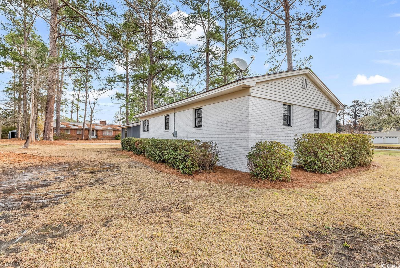 4320 Stevens Street Loris, SC 29569 - Photo 29 of 33 View of home's exterior featuring a yard and brick