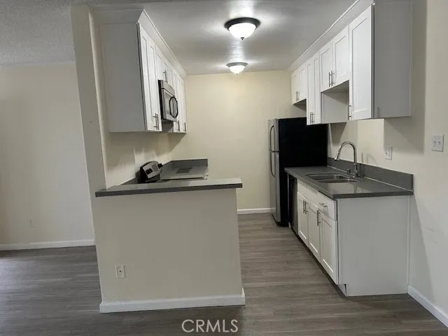 a kitchen with a sink and a refrigerator