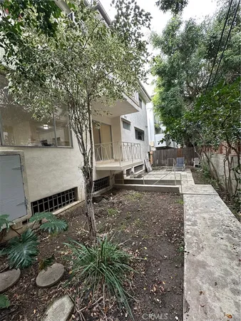 a view of a house with wooden fence