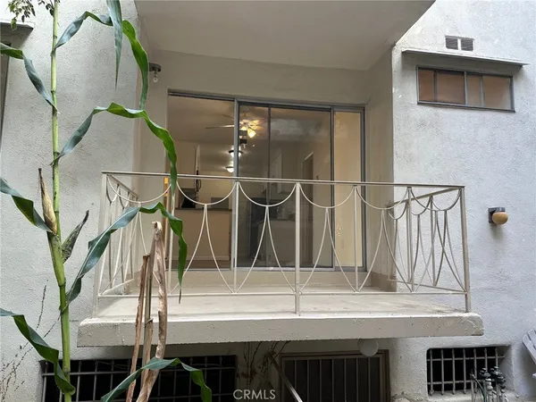 a bathroom with a granite countertop bathtub shower sink vanity and toilet