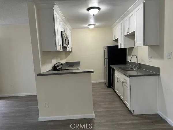 a kitchen with a sink and a refrigerator