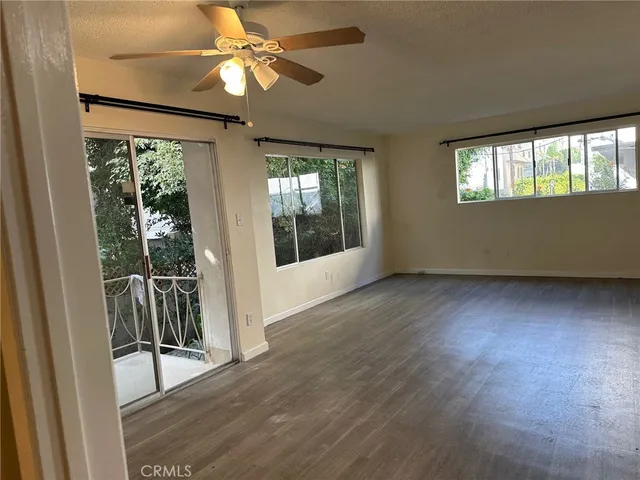 a kitchen with stainless steel appliances granite countertop a sink a stove and a wooden floors