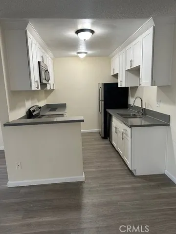 a kitchen with stainless steel appliances a sink stove and cabinets