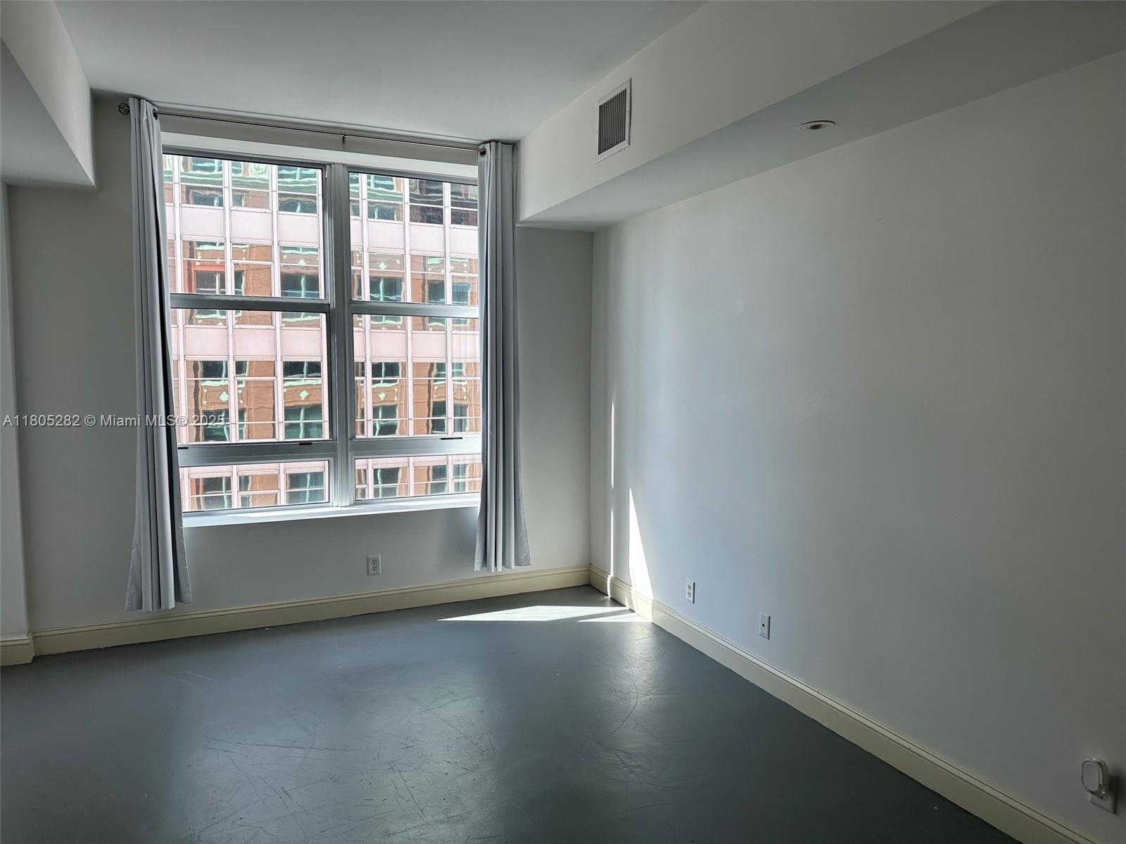 111 East Flagler Street, Unit 702 Miami, FL 33131 - Photo 7 of 11 an empty room with a window