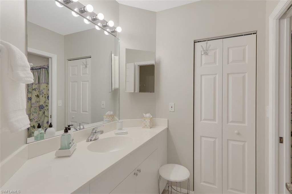 450 Launch Circle, Unit 404 Naples, FL 34108 - Photo 14 of 32 a bathroom with a sink toilet and shower