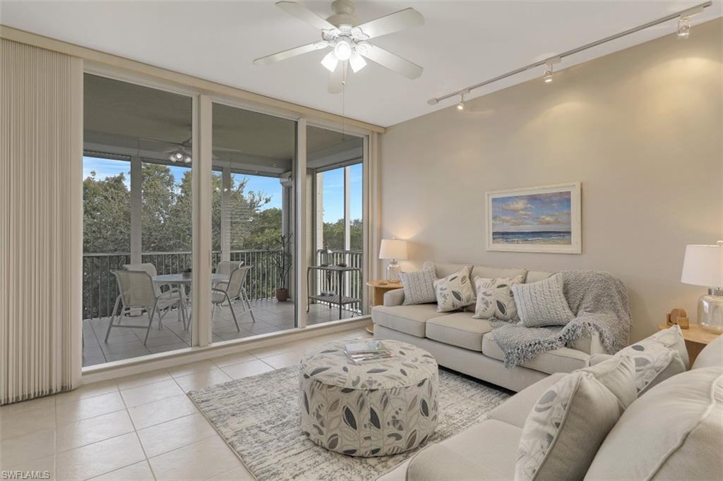 450 Launch Circle, Unit 404 Naples, FL 34108 - Photo 3 of 32 a living room with furniture and a large window with outer view