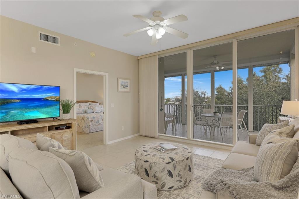 450 Launch Circle, Unit 404 Naples, FL 34108 - Photo 4 of 32 a bedroom with furniture and large windows