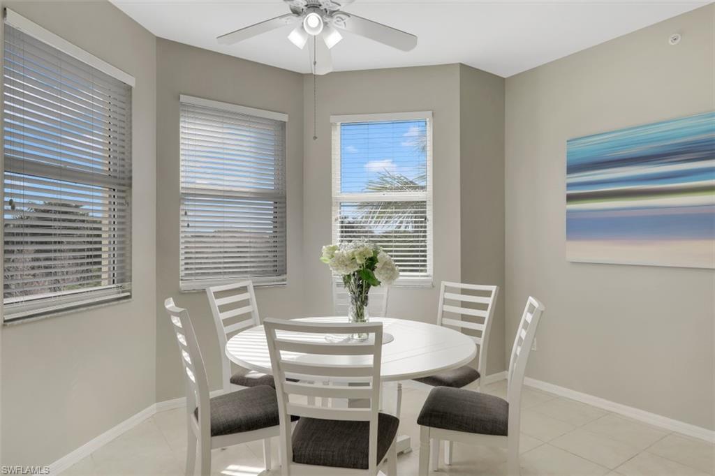 450 Launch Circle, Unit 404 Naples, FL 34108 - Photo 8 of 32 a view of a dining room with furniture and window