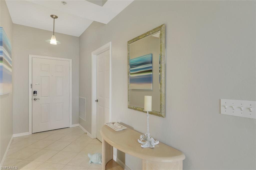 450 Launch Circle, Unit 404 Naples, FL 34108 - Photo 9 of 32 a view of a hallway with wooden floor and entryway
