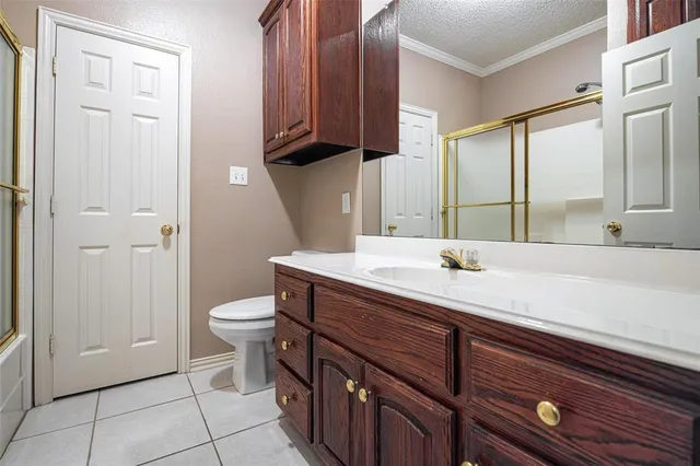 an empty room with windows and ceiling fan