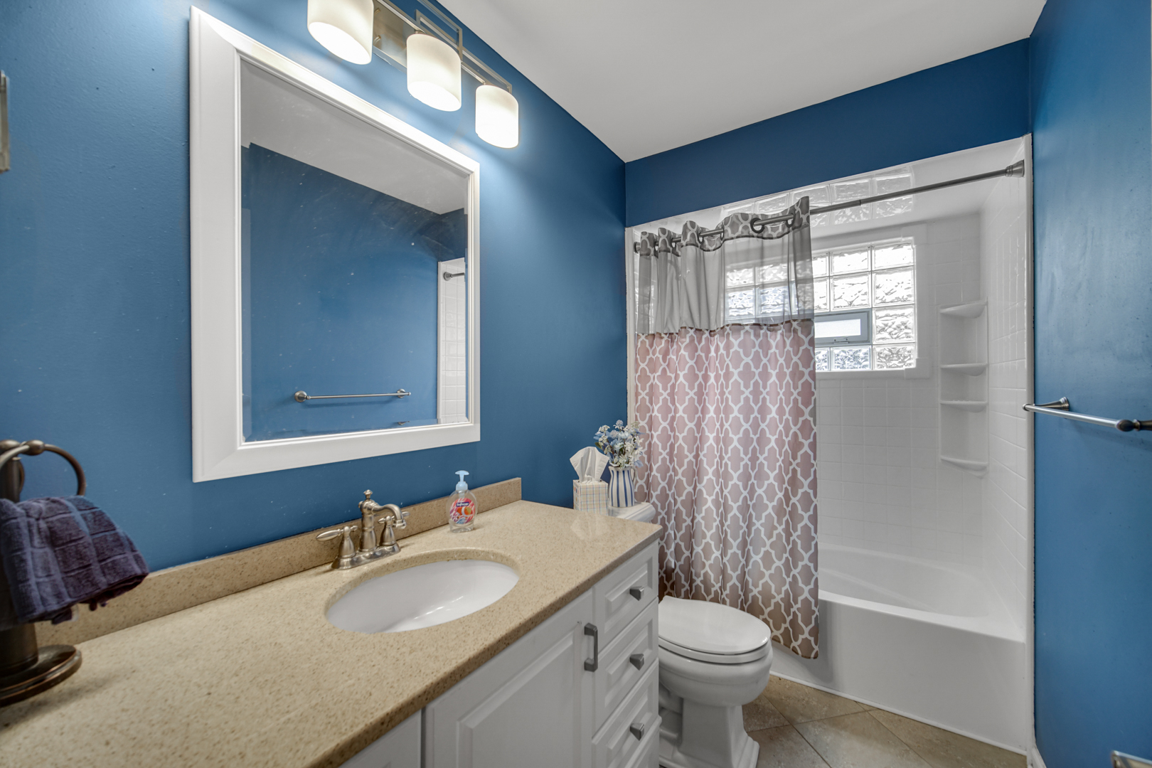 533 Drake Street Libertyville, IL 60048 - Photo 24 of 43 a bathroom with a granite countertop toilet a sink and a mirror