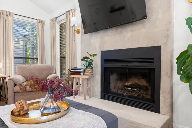 a kitchen with stainless steel appliances a sink a stove a refrigerator cabinets and wooden floor