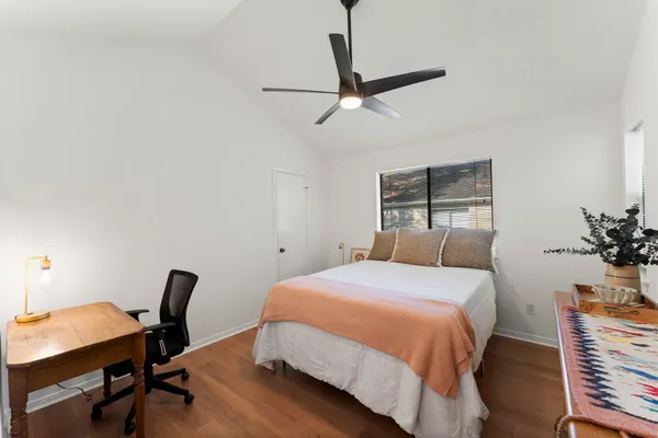 a bedroom with a bed and a chair