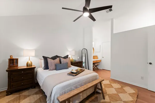a bedroom with a bed and a flat screen tv