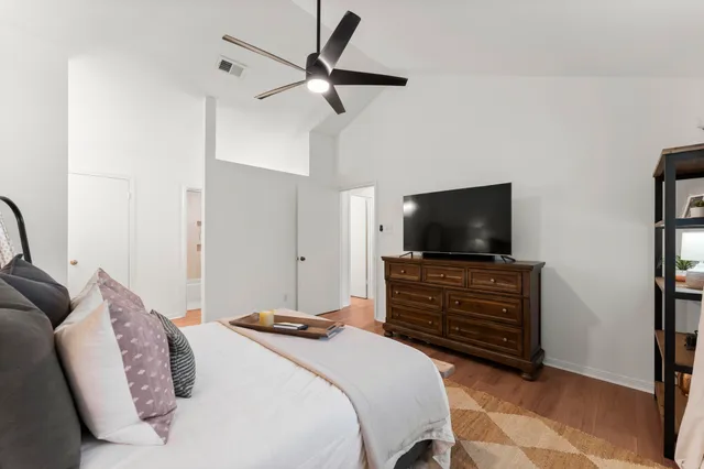 a bedroom with a bed and a flat screen tv