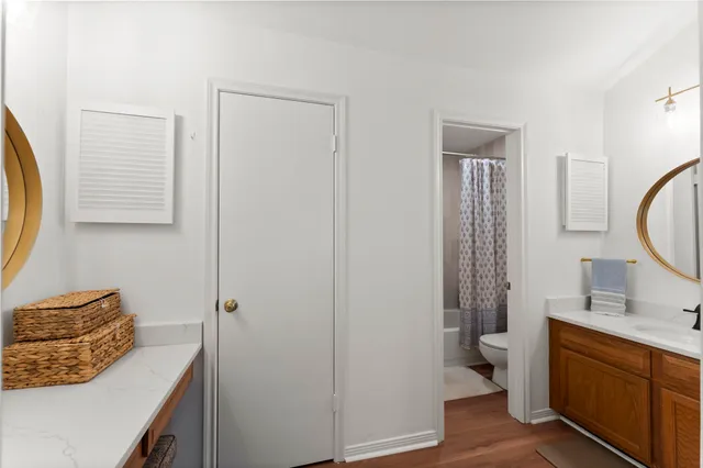 a bedroom with a bed a mirror and a window