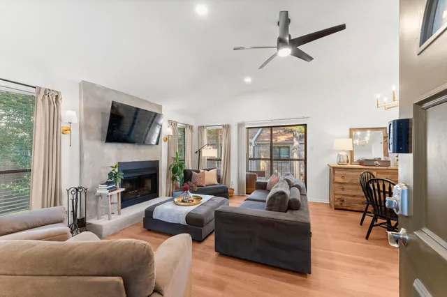 a living room with furniture fireplace and a flat screen tv
