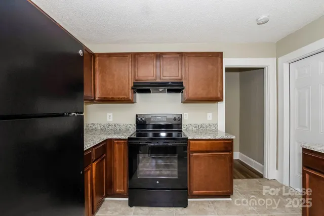 a kitchen with a sink and a stove top oven