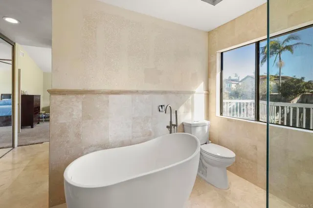 a white bath tub sitting next to a white toilet