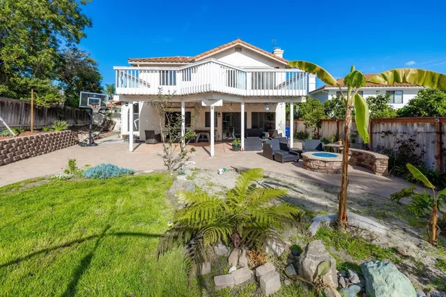 a front view of a house with swimming pool and sitting area