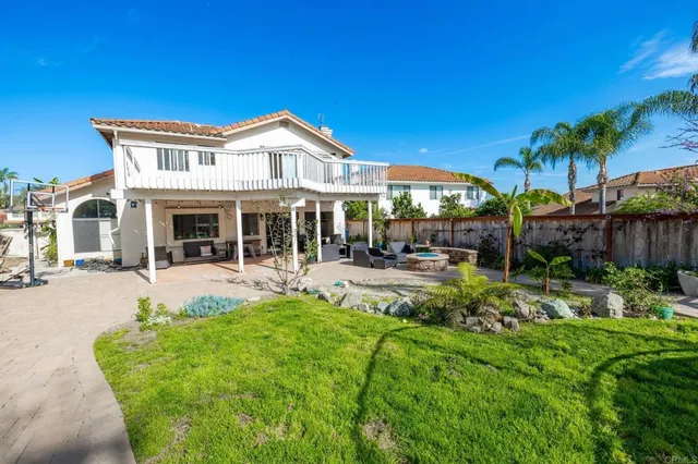 a view of a house with sitting area and garden