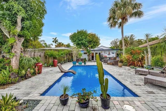 a view of a patio with couches chair and potted plants