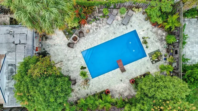 a view of house with garden and a sitting area
