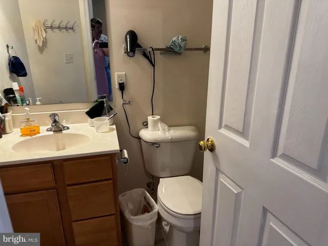 a bathroom with a sink toilet and a mirror