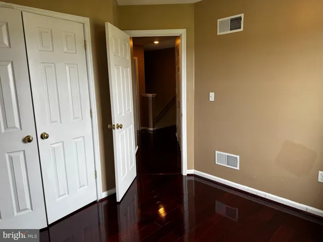 an entryway to room with wooden floor