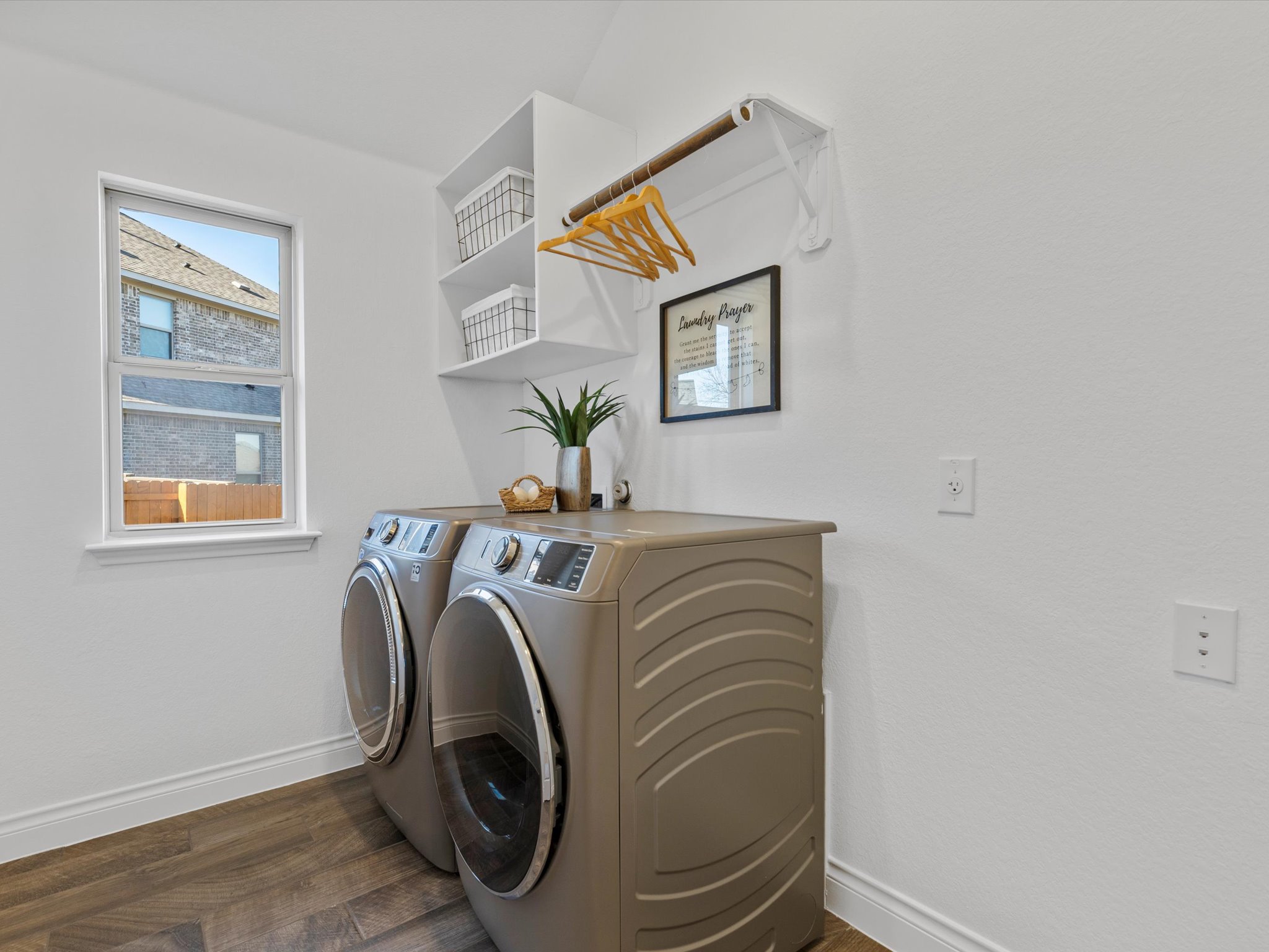 1009 Deer Rim Road Leander, TX 78641 - Photo 26 of 40 The spacious in home laundry room comes with a window, storage shelving, and a hanging rack.