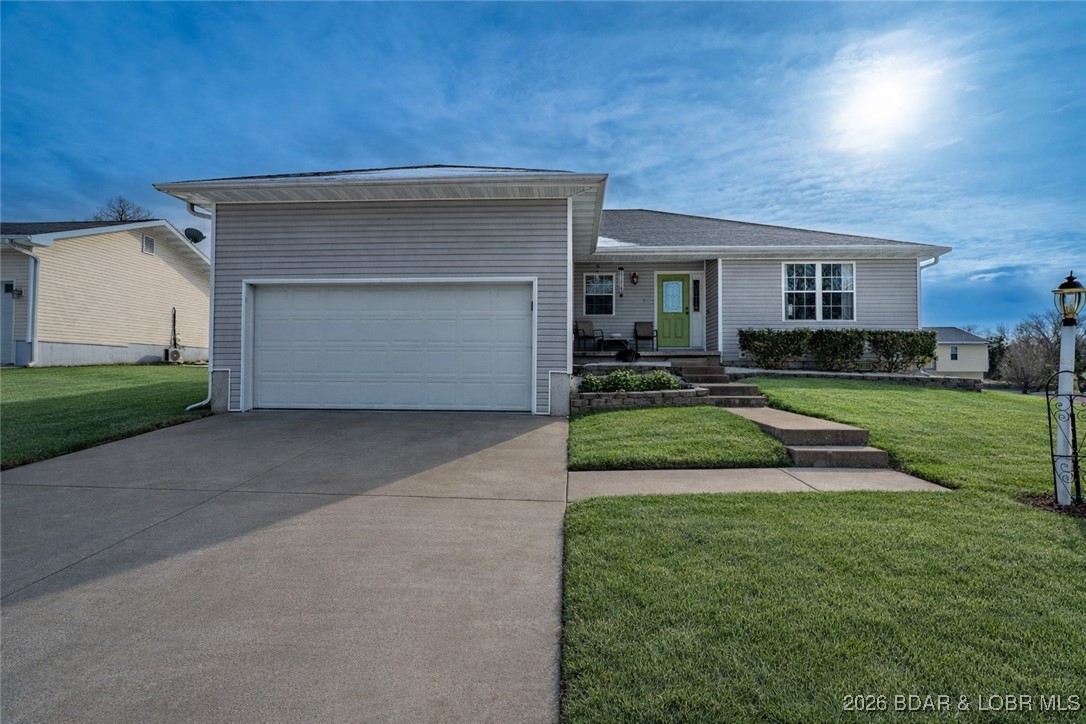 412 West Champain Street Eldon, MO 65026 - Photo 27 of 32 Decorative lamp post lights the way to the front e