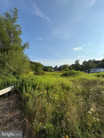 a view of a lake and green valley