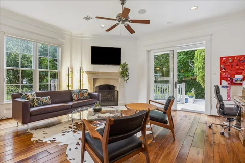 a living room with furniture fireplace and flat screen tv