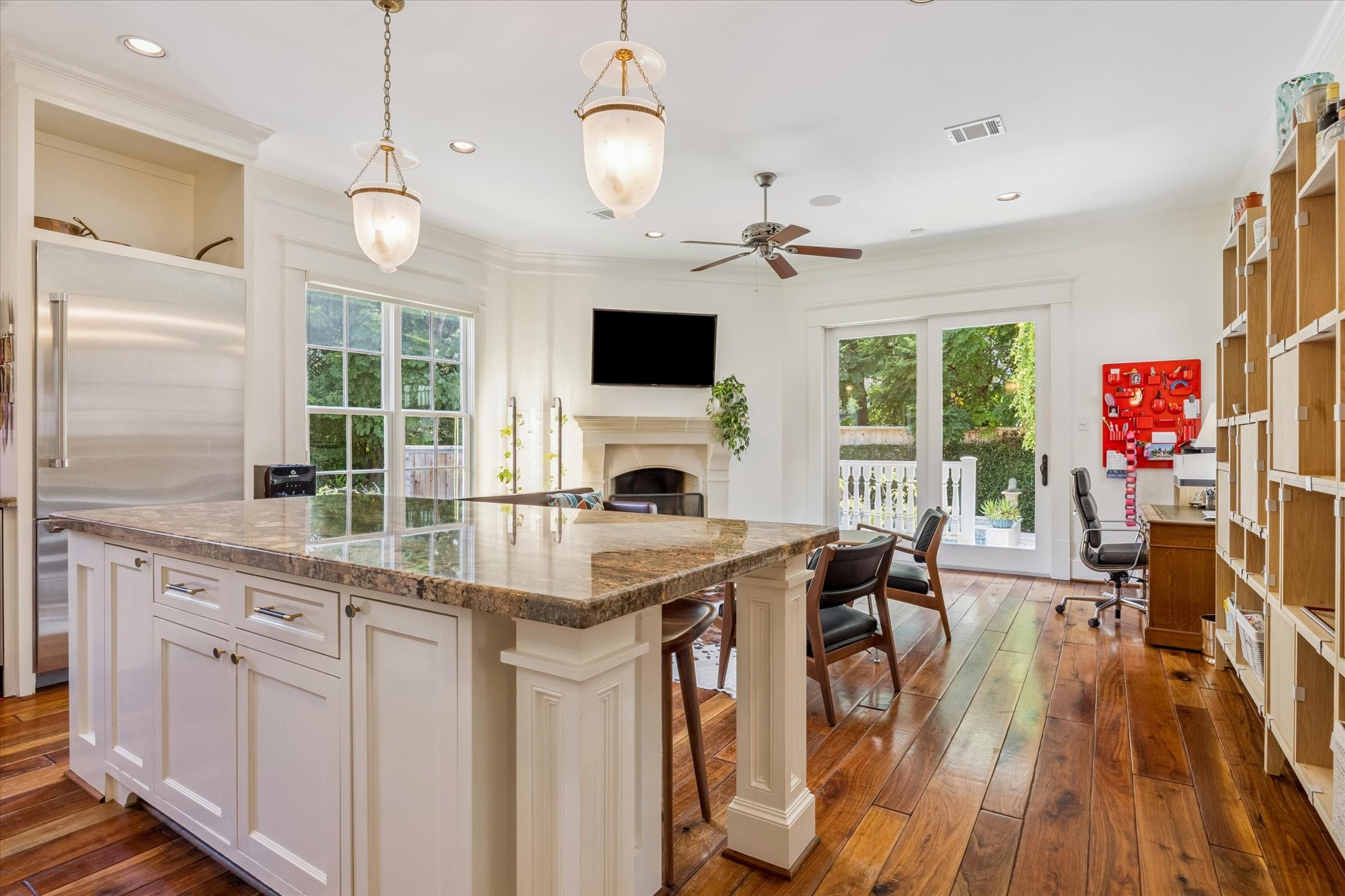 1819 Banks Street Houston, TX 77098 - Photo 17 of 43 a kitchen with stainless steel appliances granite countertop a stove top oven a refrigerator a sink dishwasher a dining table and chairs with wooden floor