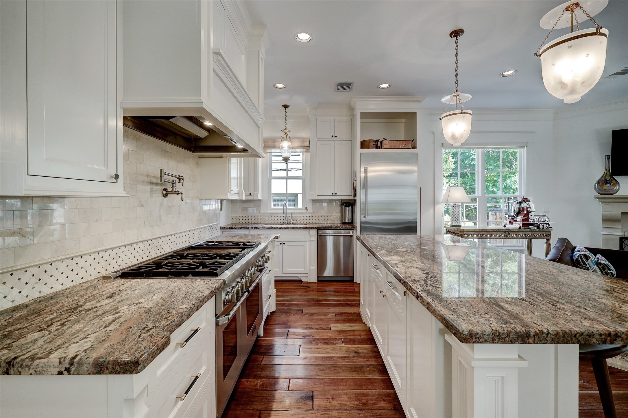 1819 Banks Street Houston, TX 77098 - Photo 18 of 43 a kitchen with granite countertop stainless steel appliances lots of counter space and wooden floors