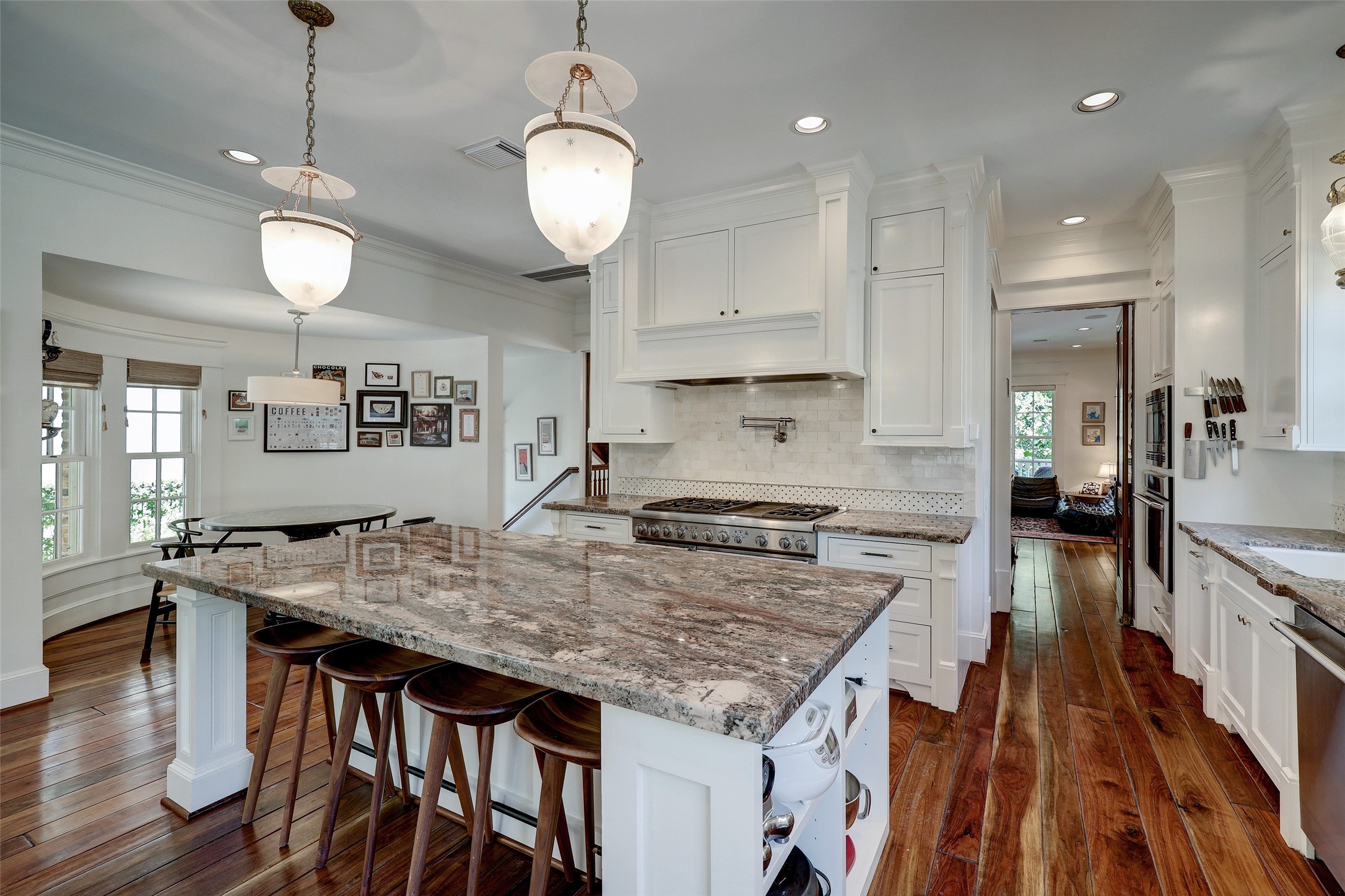 1819 Banks Street Houston, TX 77098 - Photo 19 of 43 an open kitchen with kitchen island a stove and wooden floor