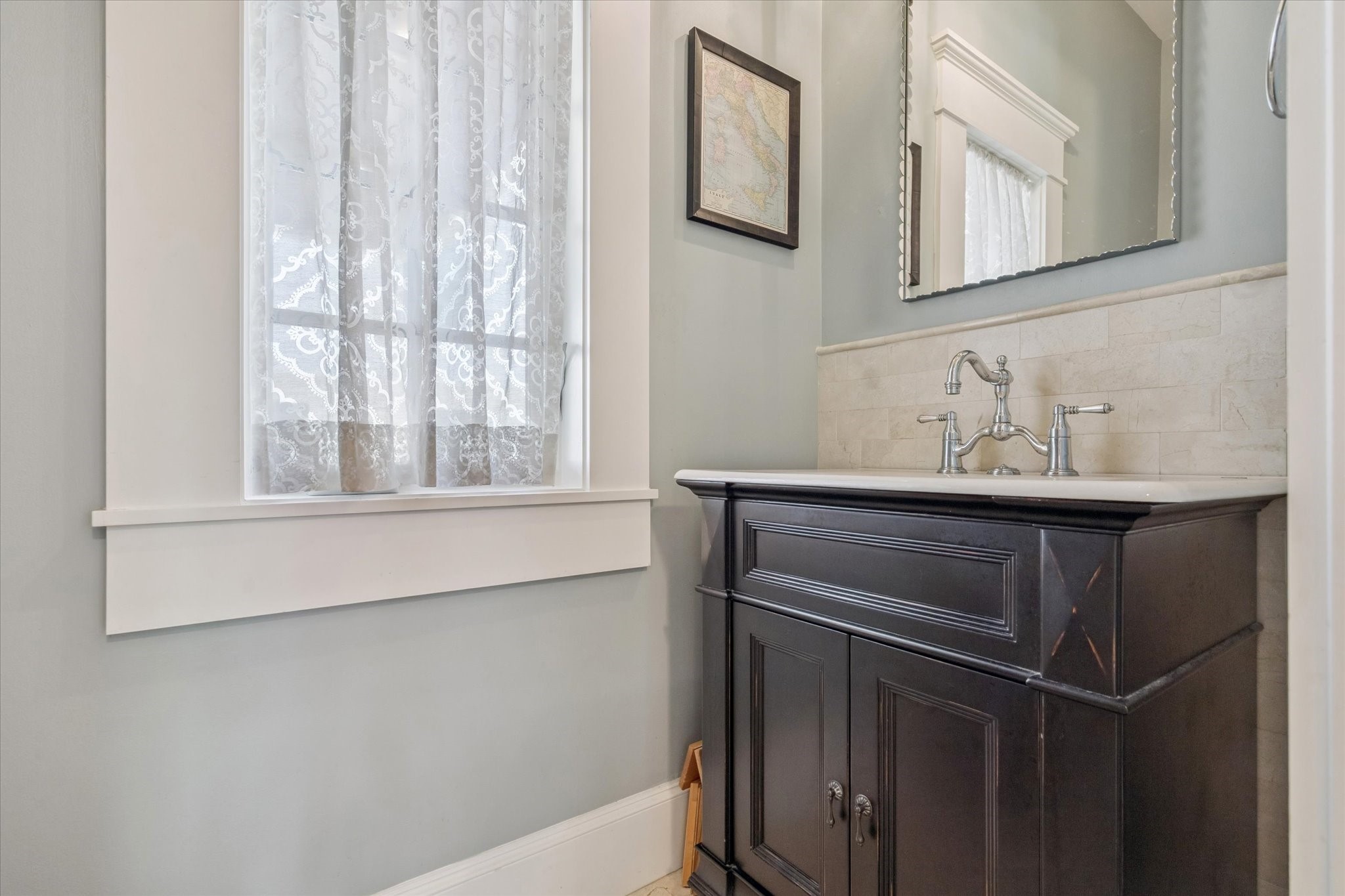 1819 Banks Street Houston, TX 77098 - Photo 30 of 43 a bathroom with a sink and a mirror