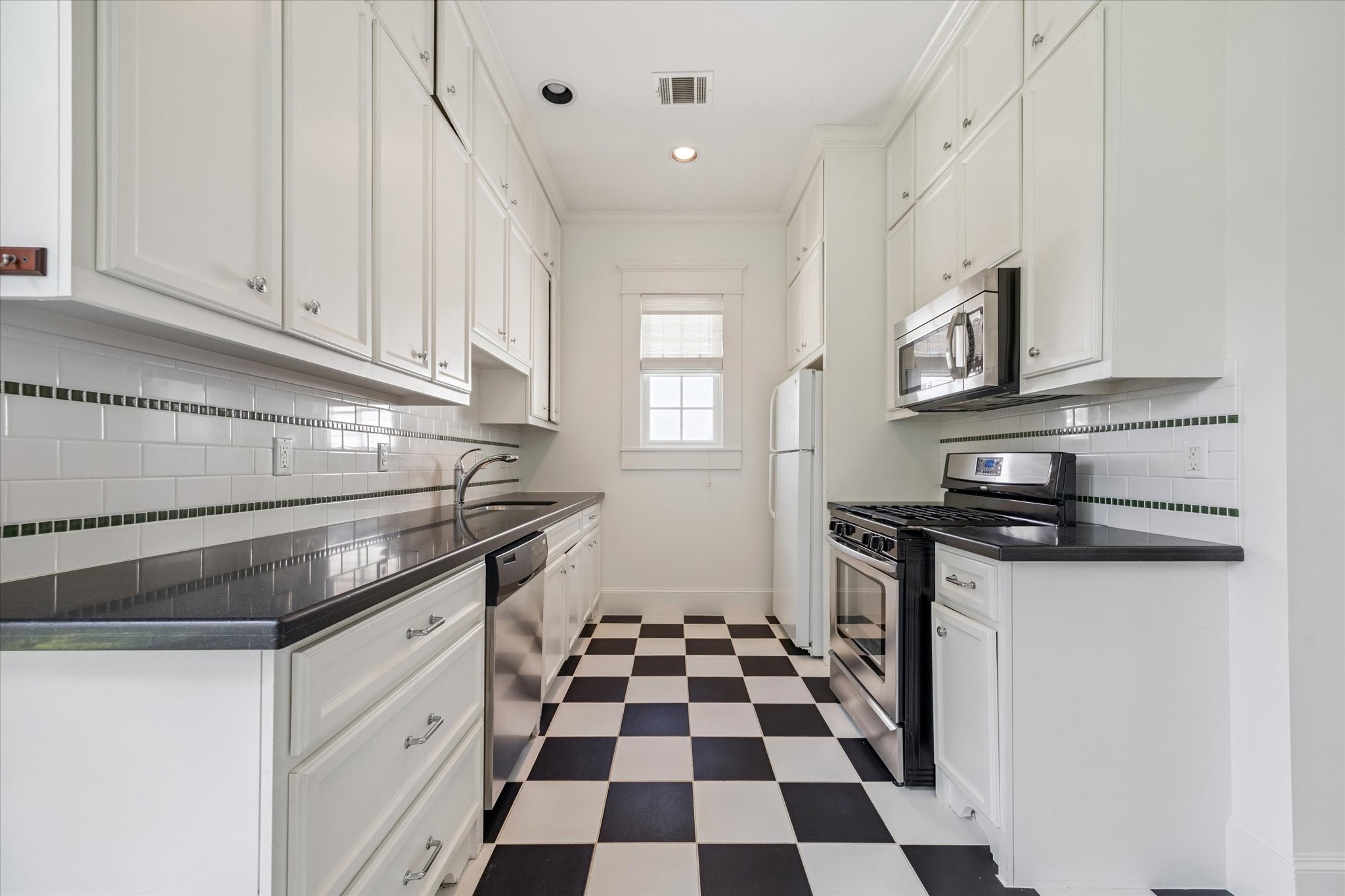 1819 Banks Street Houston, TX 77098 - Photo 37 of 43 a kitchen with granite countertop stainless steel appliances and cabinets
