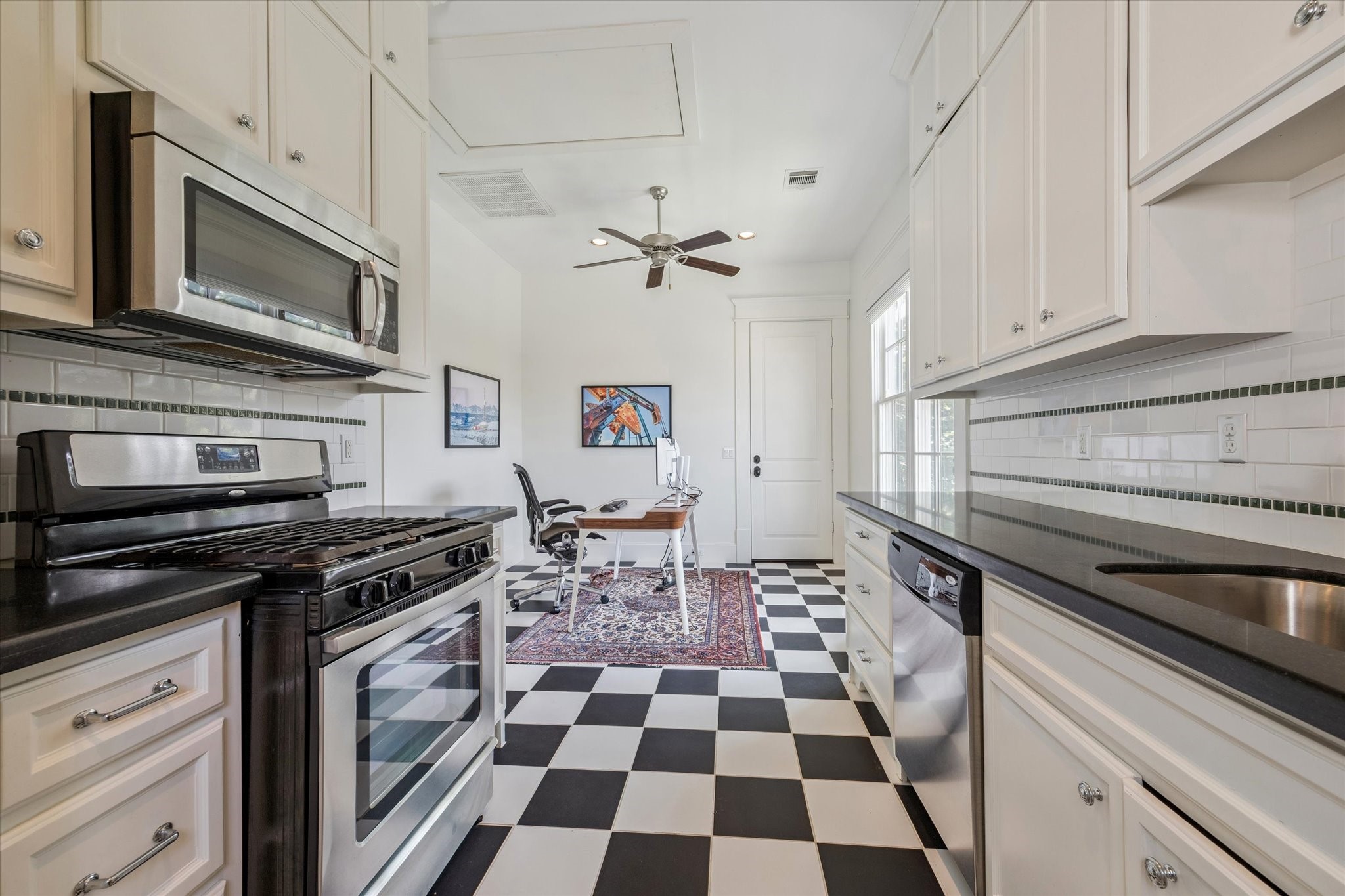 1819 Banks Street Houston, TX 77098 - Photo 38 of 43 a kitchen with stainless steel appliances granite countertop a stove a sink and a microwave