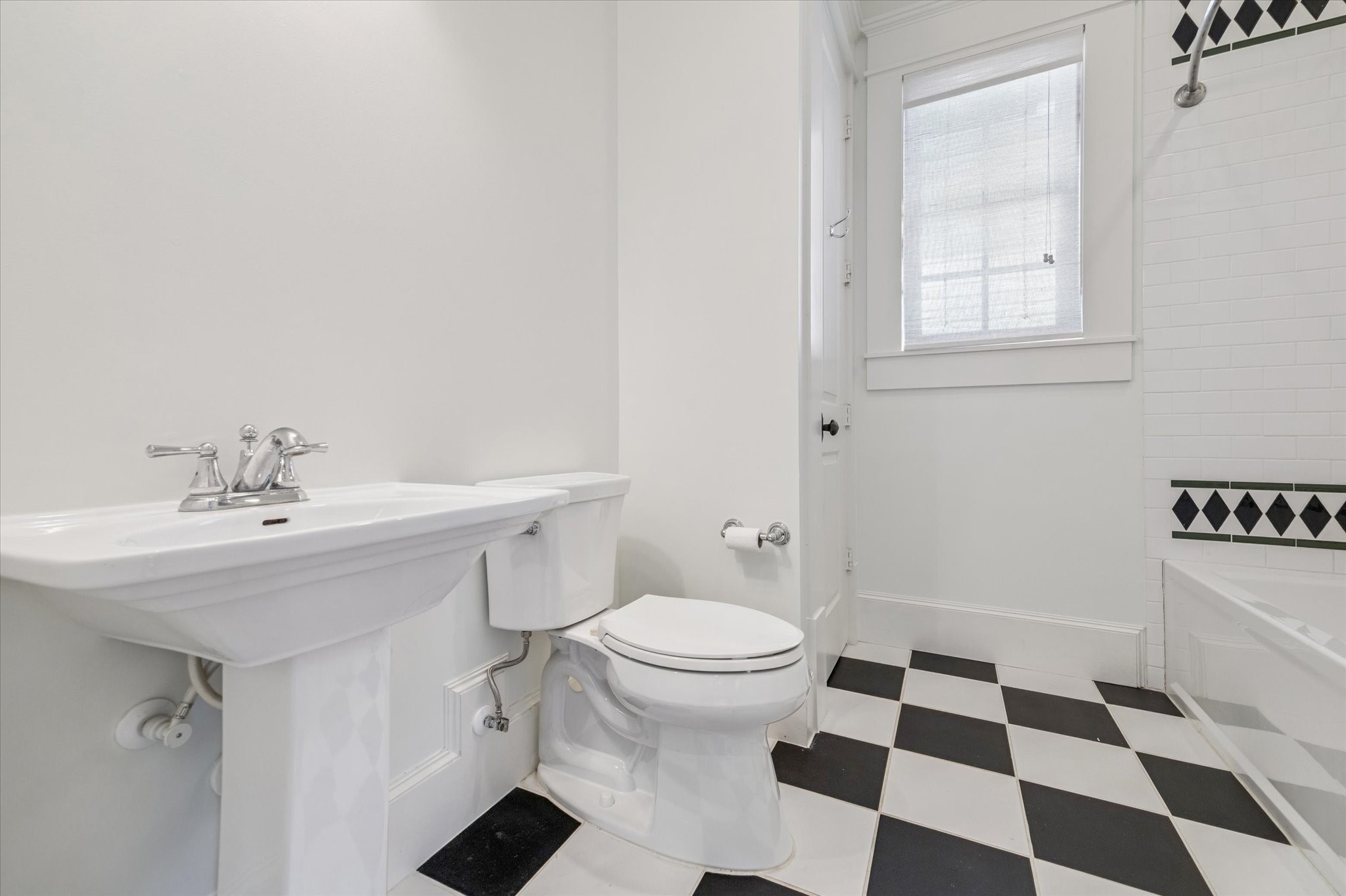 1819 Banks Street Houston, TX 77098 - Photo 39 of 43 a bathroom with a sink a toilet a window and a mirror
