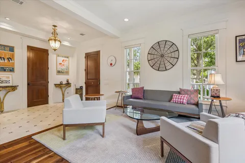 a living room with furniture and paintings