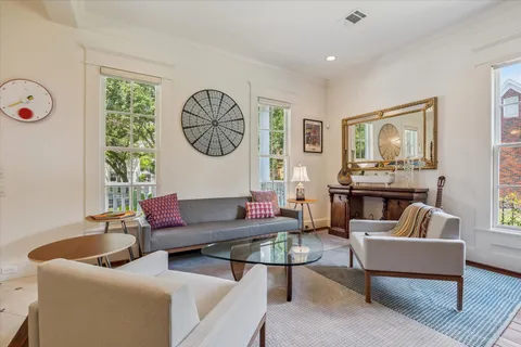 a living room with fireplace furniture and a large window