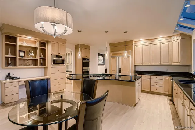 a kitchen with stainless steel appliances granite countertop a stove a sink and a refrigerator